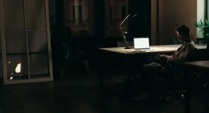 man at computer at night